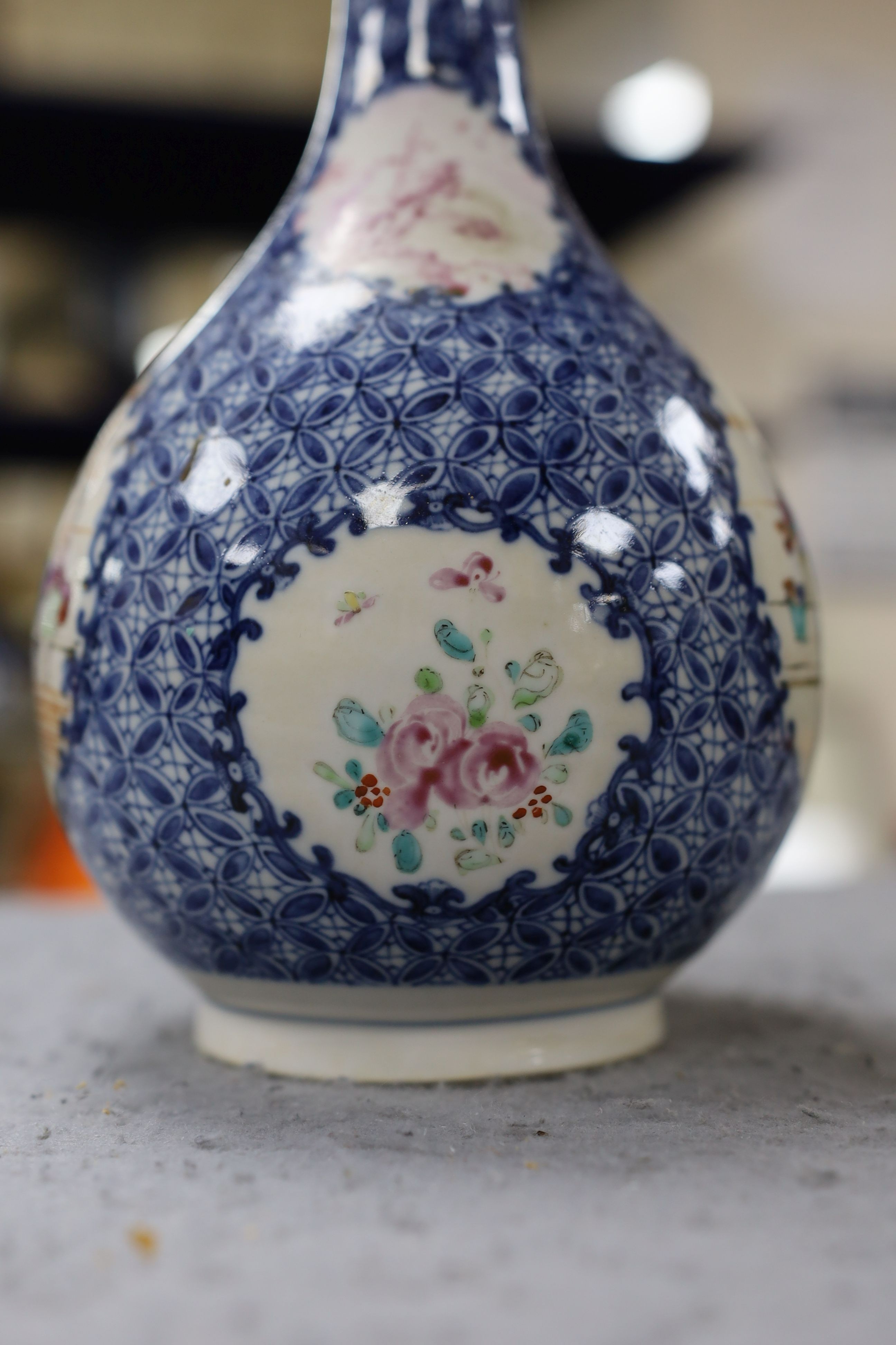 A pair Samson of Paris vases in the Chinese famille verte style and a Chinese Qianlong famille rose garlic neck vase with blue panelling motif, tallest 26cm